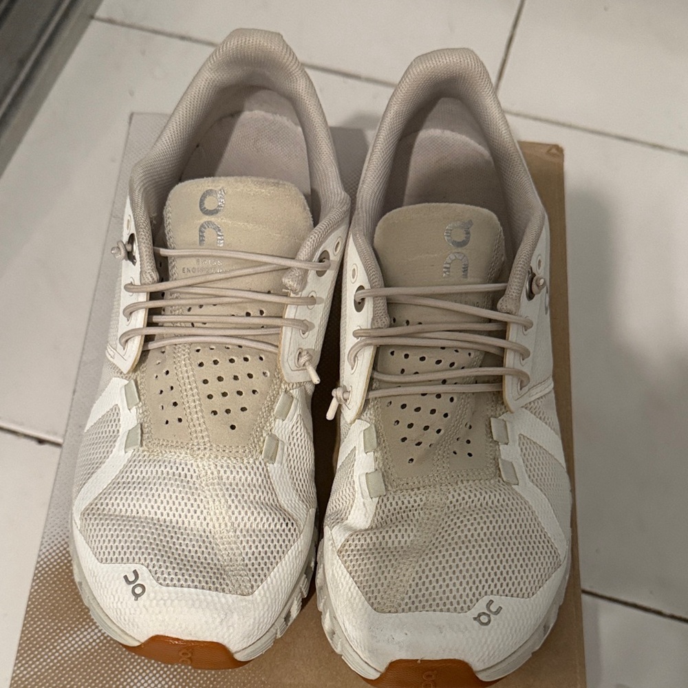 On Running Cream and White Athletic Shoes